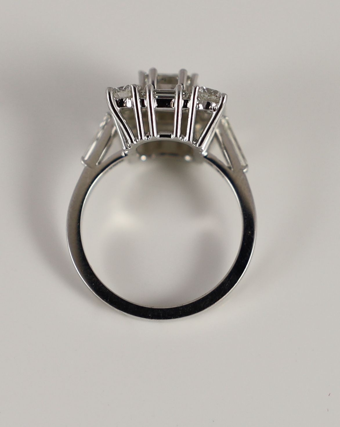 A square, baguette and round cut diamond set square cluster ring